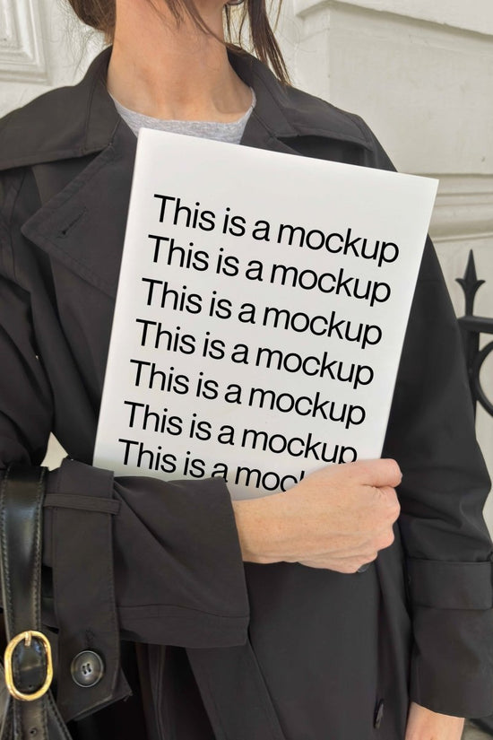 Holding Magazine with Trench Coat Mockup - Mock Exchange
