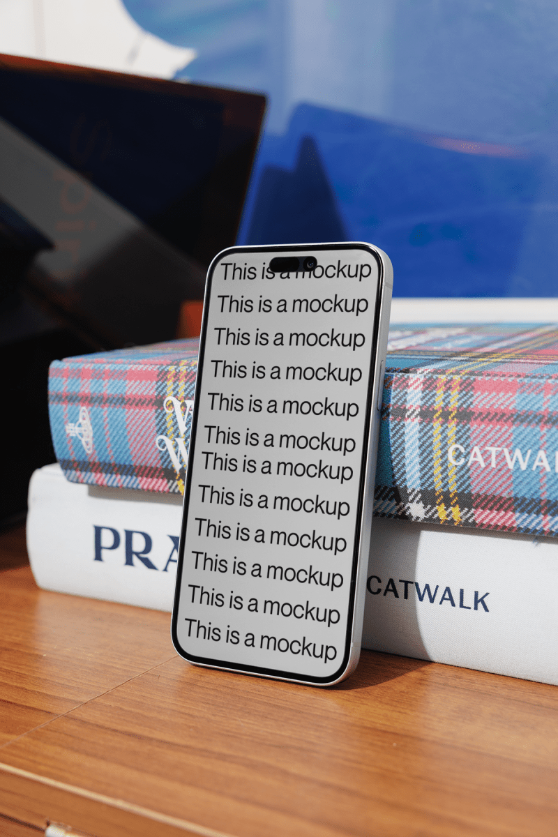 iPhone Mockup Leaning on Books - Mock Exchange