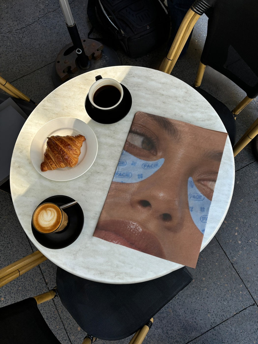 A logo on a real photo of a newspaper open on a cafe table